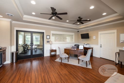 Clubhouse lounge with seating, a coffee bar, and a door leading to the fitness center.