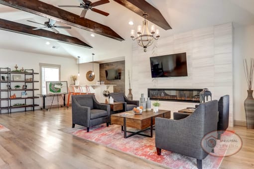 Clubhouse Lounge with fireplace, flat-screen TV, coffee bar, and lounge area.
