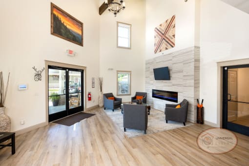Clubhouse Lounge with fireplace, flat-screen TV, coffee bar, and lounge area.