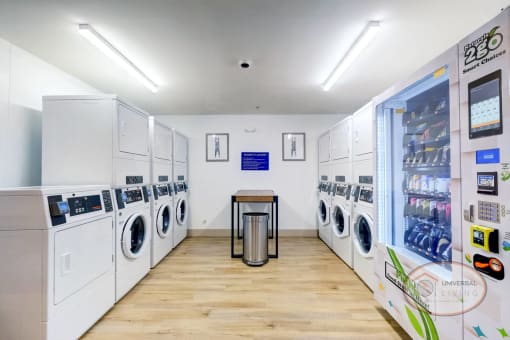 A laundry center with washers, dryers, and seating.