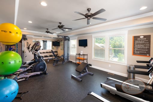 A fitness center featuring weight training equipment and cardio equipment.