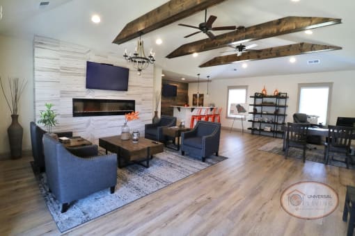 a large living room with a wood floor and a tv on the wall