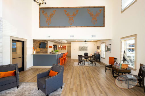 Clubhouse lounge with leasing office, coffee bar, TV, fireplace, and more.