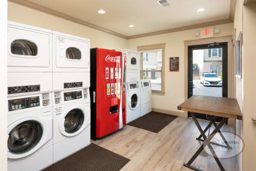 a laundry room with washing machines and a red vending machine