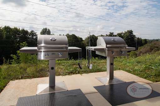 Two stainless steel grills under the pavilion.