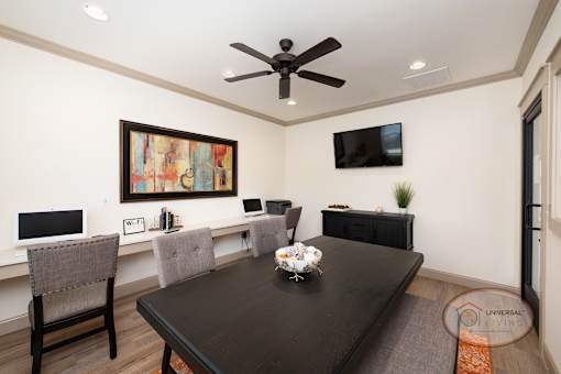 The business center with free Wi-Fi and computers, complete with flat screen TV and seating.
