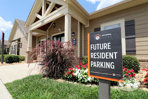 A sign in front of the clubhouse that says Future Resident Parking.