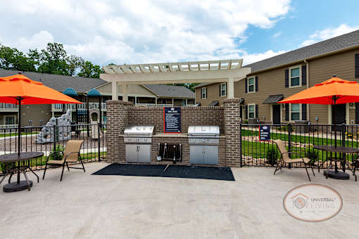 Two stainless steel grills on the patio by the pool.