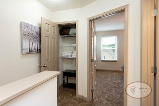 A view of a broom closet at the top of the stairs.