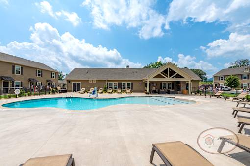 A different angle of the zero entry saltwater swimming pool with the clubhouse in the background.