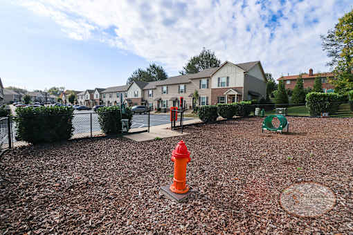 A red fire hydrant sits in the middle of a gravel area.