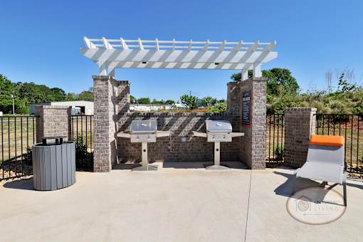 Two stainless steel grills on the patio by the pool.