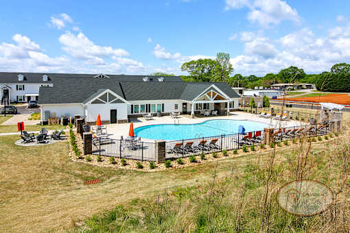 A sweeping view of the apartment community's clubhouse, zero entry pool and other amenities.