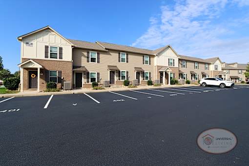 A parking lot in front of a building with the words Universal Living on it.