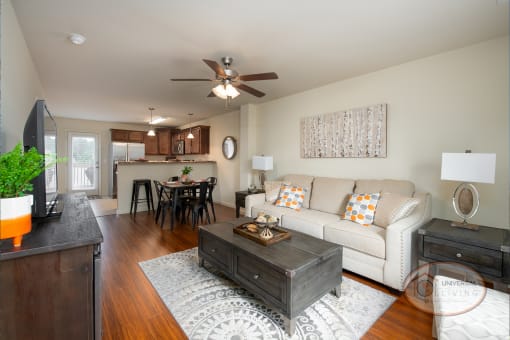 a living room and kitchen with a couch and a table