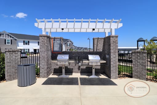 A grill station sits next to the pool, complete with trash can and grilling tools.