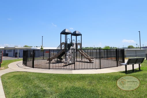 A soft topped playground with seating.