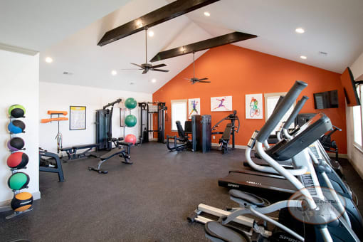 A fitness center with weight training and cardio equipment.