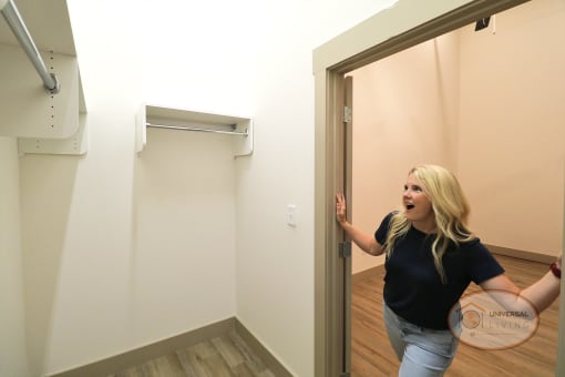 A woman looking into a large, walk-in closet.