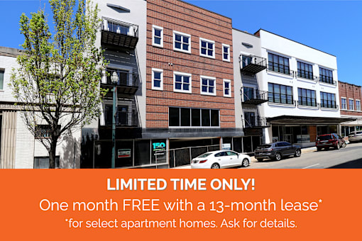 Apartment complex with a sign offering a free month with a 13-month lease.