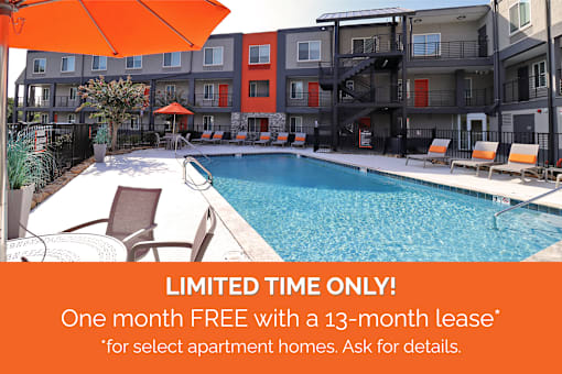 A pool surrounded by chairs and umbrellas with a sign offering a free month with a 13-month lease.