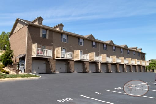 an image of a condo building with a parking lot
