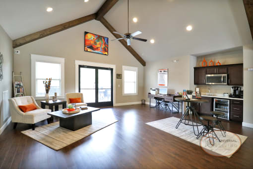 the view of a living room with a dining room and a kitchen