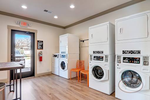 The on-site laundry center for residents with washers, dryers, and seating.