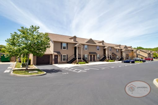 A two story stacked apartment building with garages on end.