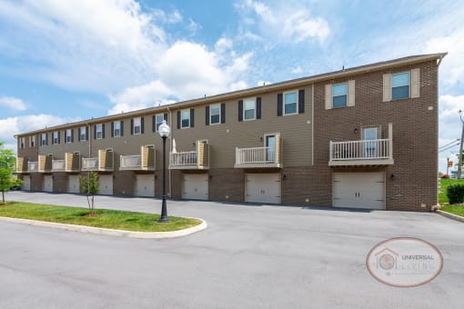 Rear of a two and three bedroom apartment home building with balconies and drive under garages.