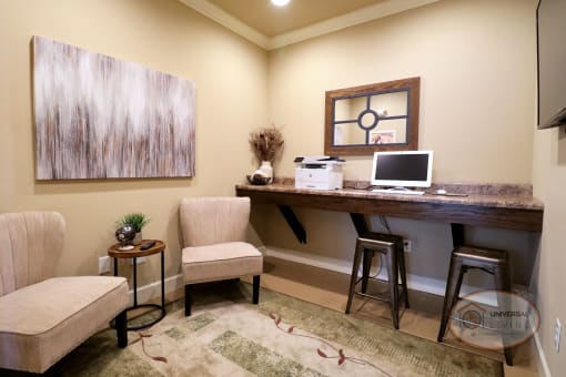 The business center with seating, computer, and printer.