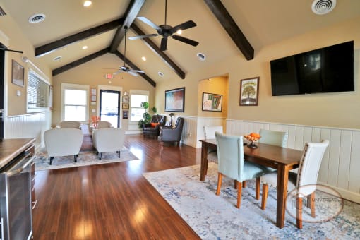 The clubhouse lounge with chairs, flat screen TV, and coffee bar.