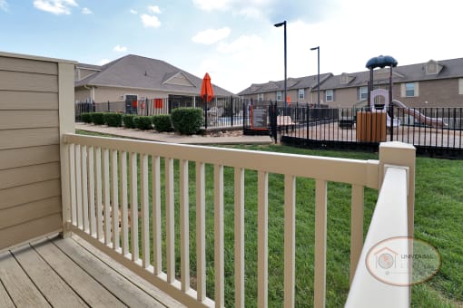 View from a patio of the playground and pool.