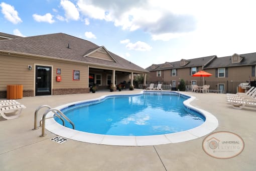 A saltwater swimming pool surrounded by lounge chairs.