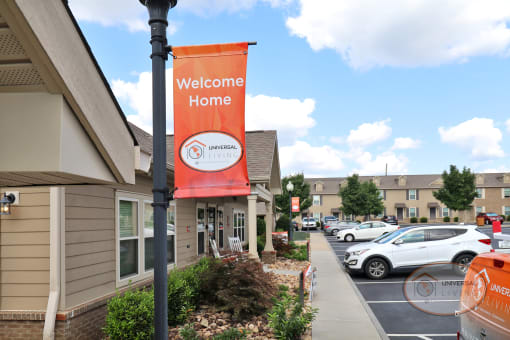 An orange banner reading "Welcome Home" is visible with apartments in the background.