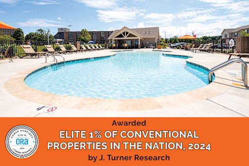 A swimming pool with a banner that reads Awarded Elite 1% of Conventional Properties in the Nation, 2024 by J. Turner Research.