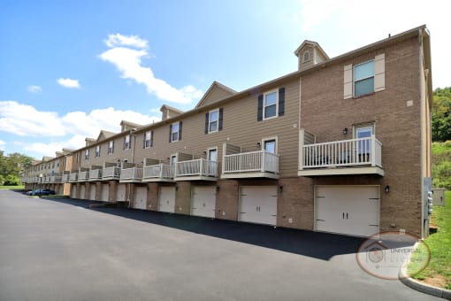 The rear of a two and three bedroom apartment home with balconies and garages.