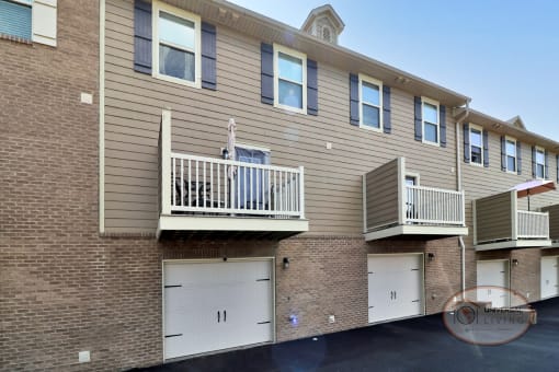 An apartment building with  balconies over garages.