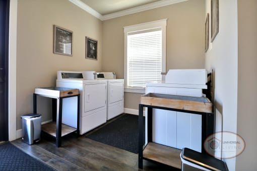 The laundry center with washers, dryers, and tables.