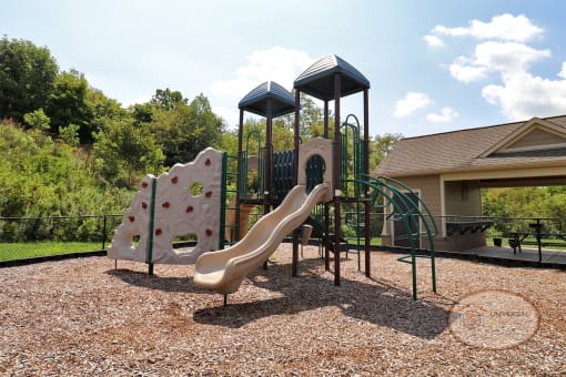 A fenced in, soft topped playground.