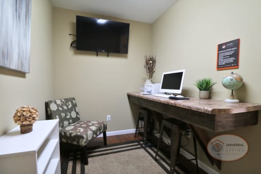 A business center with computer and TV.