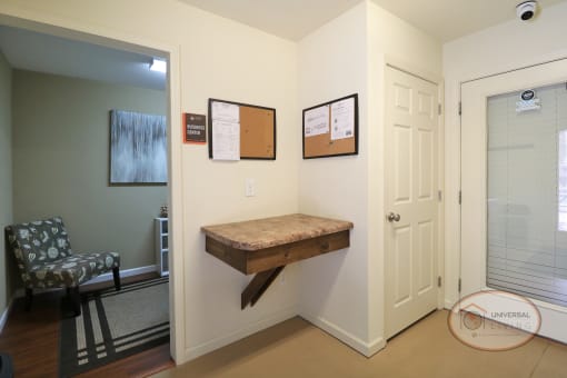 A laundry center with washers and dryers and a table.