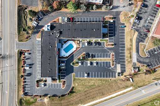 An aerial view of a The Hub at Mountcastle from directly above, showcasing the parking lot and pool.