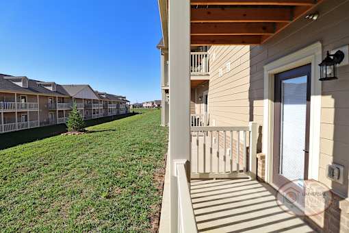 the view from the front porch of a house with a grass lawn and a yard