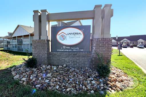 a sign for the universal town center in front of a building