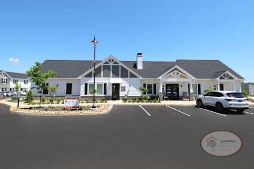 The front of the white and gray clubhouse and leasing office.
