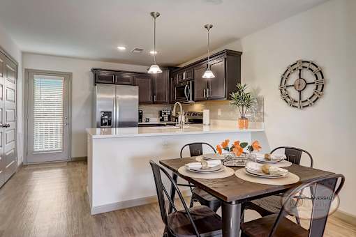 A kitchen with stainless steel appliances and a white quartz counter top.