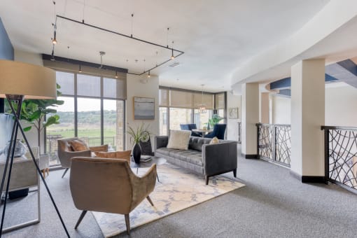 a living room with couches and chairs and a balcony