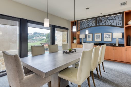 a dining room with a long table and chairs