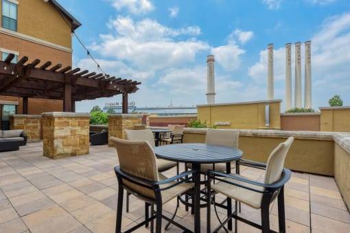 a patio with a table and chairs on a roof